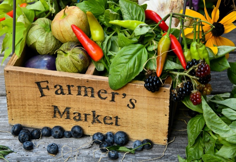 Wooden farmers market crate with fresh vegetables